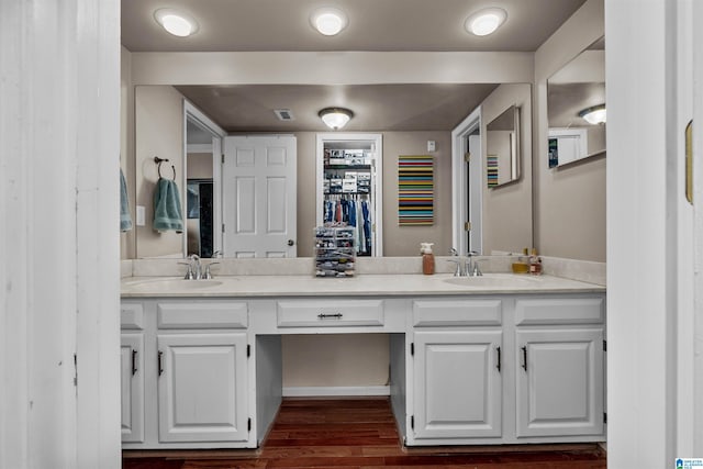 bathroom with hardwood / wood-style floors and vanity