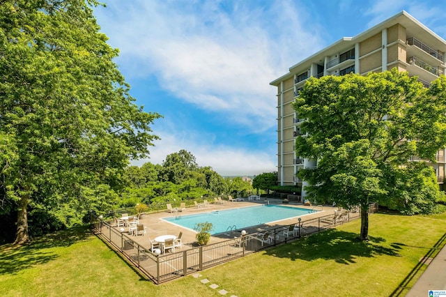 view of swimming pool featuring a lawn and a patio area