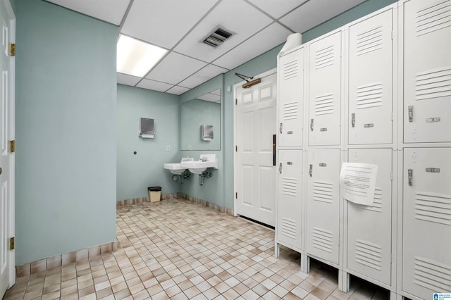 bathroom with tile patterned flooring and a paneled ceiling