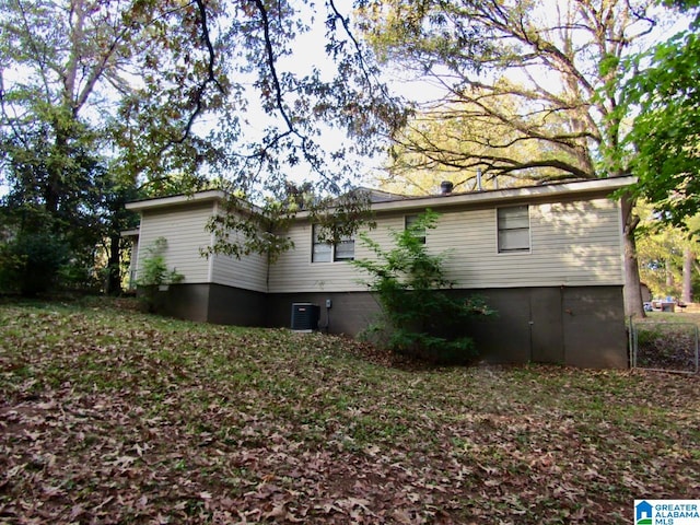 back of house featuring central air condition unit