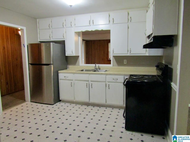 kitchen with sink, black range with electric stovetop, extractor fan, stainless steel refrigerator, and white cabinetry