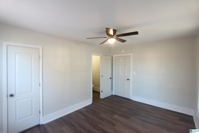 unfurnished bedroom with dark hardwood / wood-style flooring and ceiling fan