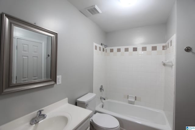 full bathroom featuring toilet, vanity, and tiled shower / bath