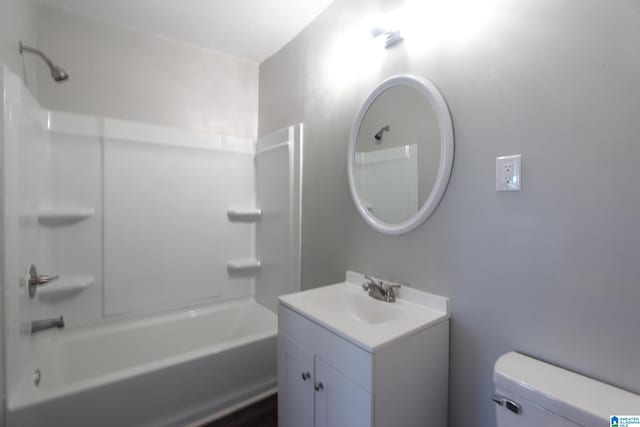 full bathroom featuring toilet, vanity, and bathing tub / shower combination