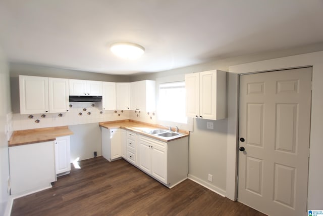 kitchen with white cabinets, butcher block countertops, backsplash, and dark hardwood / wood-style flooring