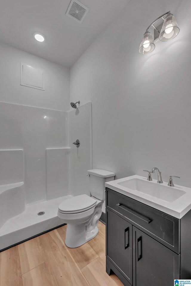 1174 Ranch Marina Rd, Pell City, AL 35128 - full bath with a shower, toilet, wood finished floors, and vanity