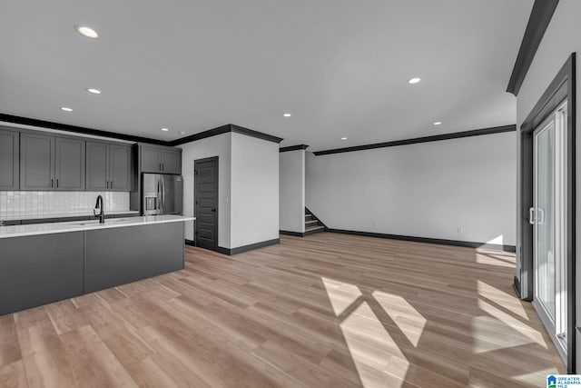 1174 Ranch Marina Rd, Pell City, AL 35128 - kitchen featuring ornamental molding, open floor plan, light countertops, tasteful backsplash, and baseboards
