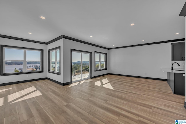 1174 Ranch Marina Rd, Pell City, AL 35128 - unfurnished living room with ornamental molding, plenty of natural light, baseboards, light wood finished floors, and recessed lighting