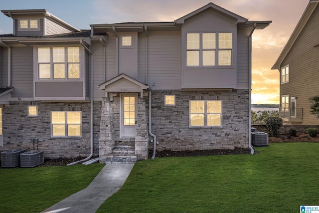 1174 Ranch Marina Rd, Pell City, AL 35128 - view of front facade featuring stone siding, a front yard, and cooling unit