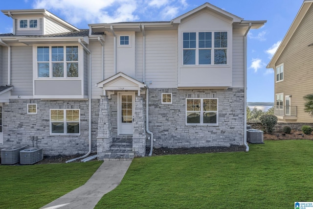 1174 Ranch Marina Rd, Pell City, AL 35128 - view of front facade with stone siding, a front lawn, and central AC