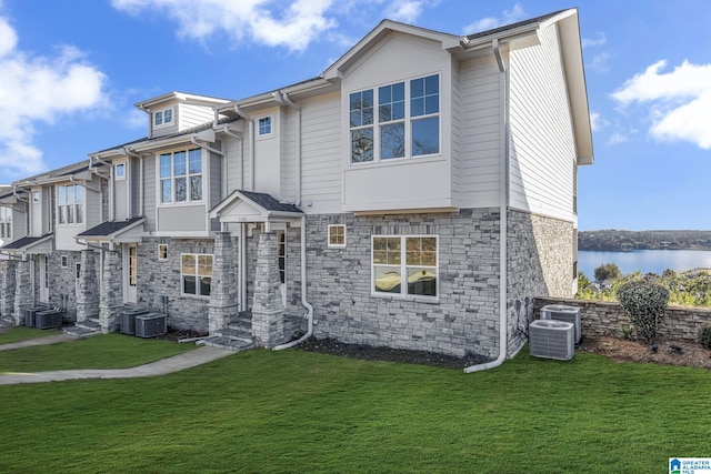 1174 Ranch Marina Rd, Pell City, AL 35128 - view of front of home with a front yard, stone siding, cooling unit, and a water view