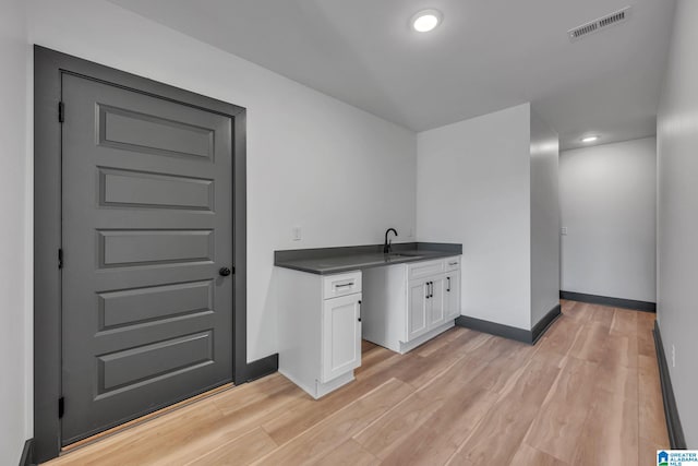 1174 Ranch Marina Rd, Pell City, AL 35128 - laundry area featuring baseboards, light wood-style floors, a sink, and recessed lighting
