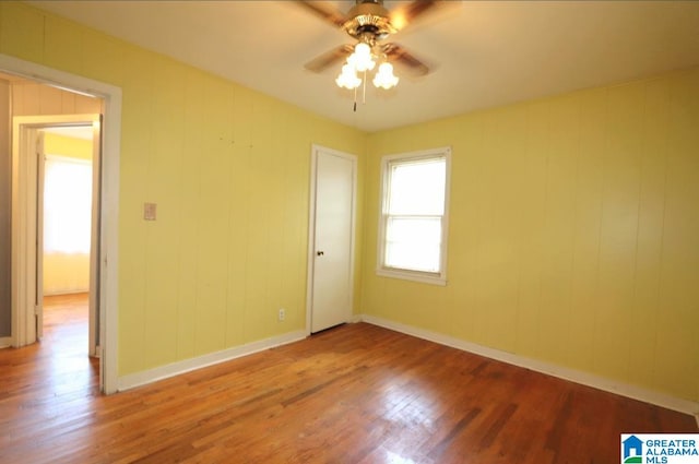 unfurnished room featuring hardwood / wood-style floors and ceiling fan