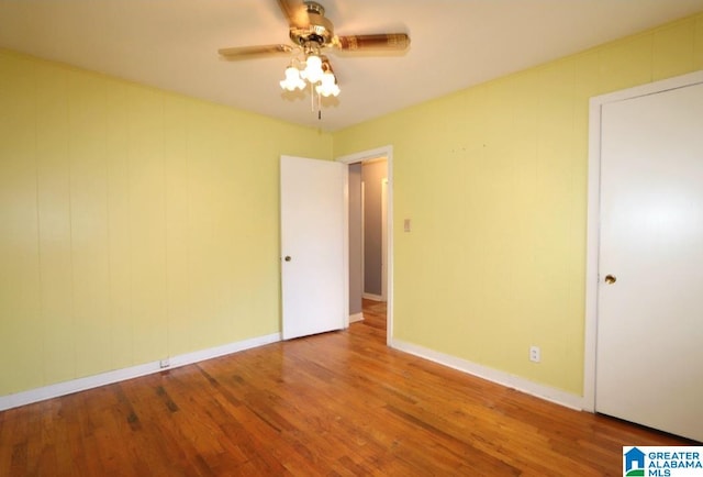 unfurnished bedroom featuring wood-type flooring and ceiling fan