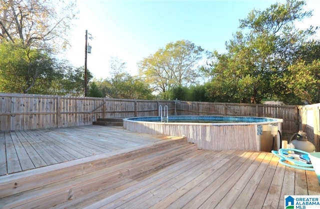 deck with a fenced in pool