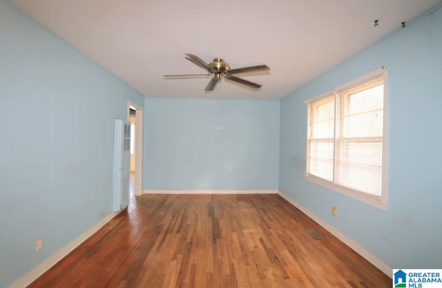 unfurnished room with hardwood / wood-style floors and ceiling fan