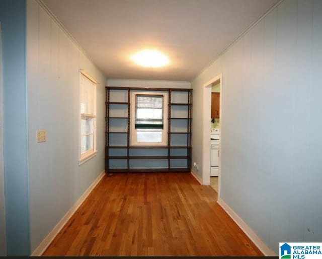 hall featuring ornamental molding and wood-type flooring