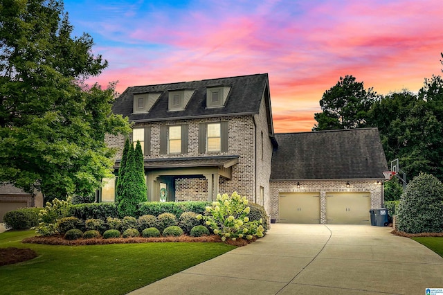 view of front of property with a garage and a yard