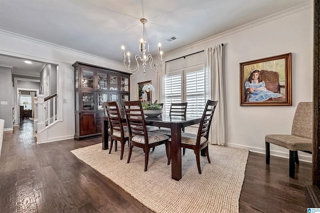 dining space featuring dark wood-type flooring, a chandelier, and ornamental molding