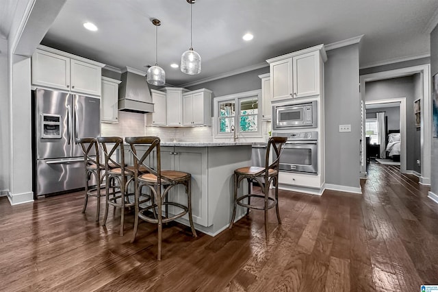 kitchen featuring dark hardwood / wood-style flooring, pendant lighting, white cabinets, and stainless steel appliances