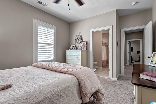 carpeted bedroom with connected bathroom and ceiling fan