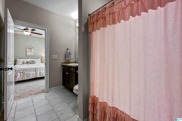 bathroom featuring toilet, vanity, tile patterned floors, and ceiling fan