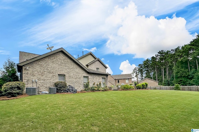 back of property featuring a lawn and cooling unit