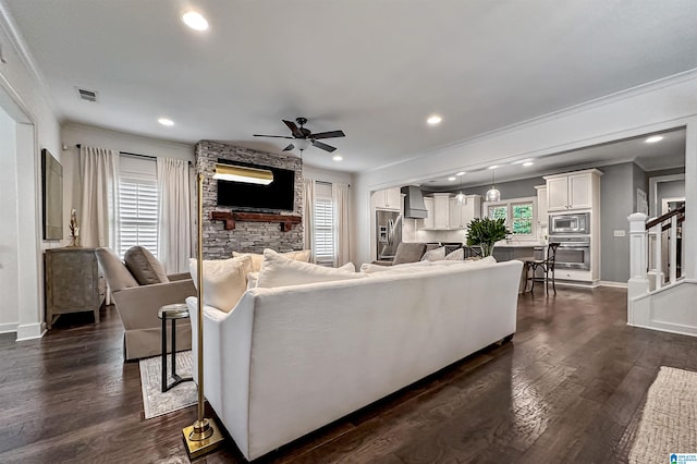 living room with ceiling fan, crown molding, a healthy amount of sunlight, and dark hardwood / wood-style floors