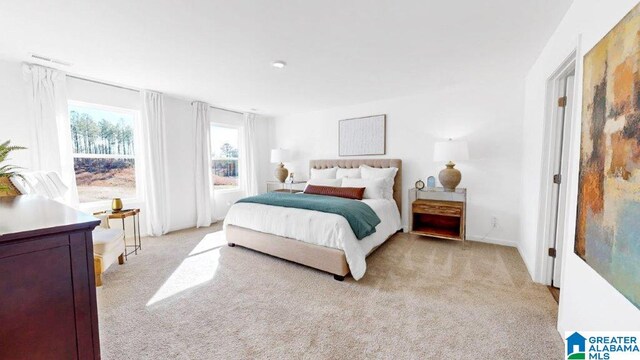 bedroom featuring light carpet