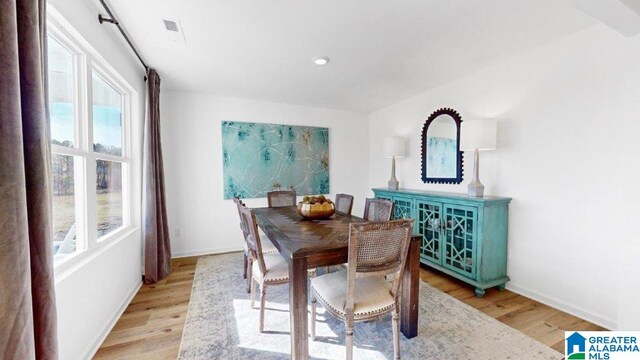 dining room featuring a wealth of natural light and light wood-type flooring