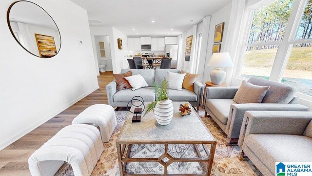 living room with plenty of natural light and light wood-type flooring