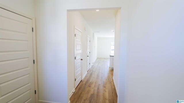 corridor with light hardwood / wood-style floors