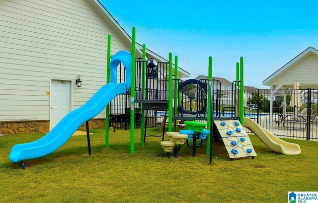 view of playground with a lawn