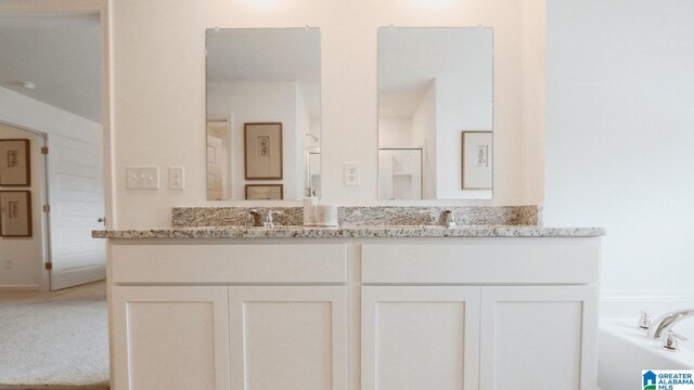 bathroom featuring a bath and vanity