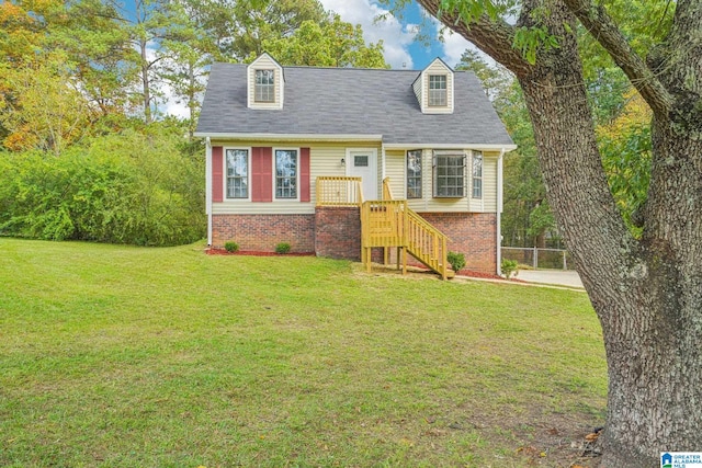 cape cod house featuring a front yard