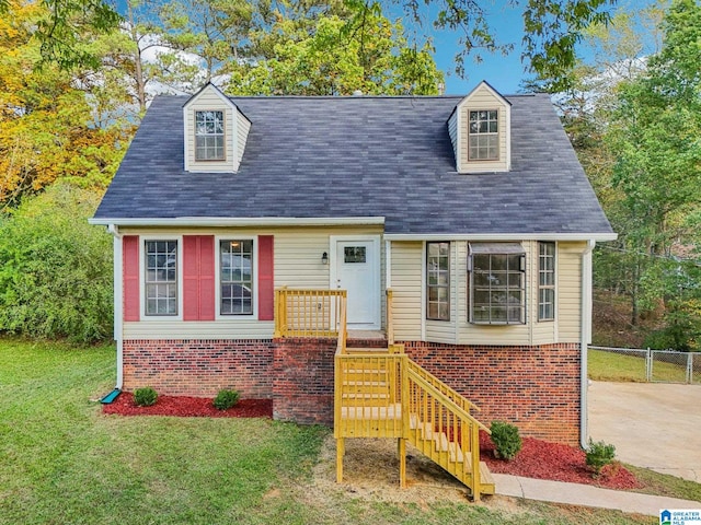 cape cod-style house with a front lawn