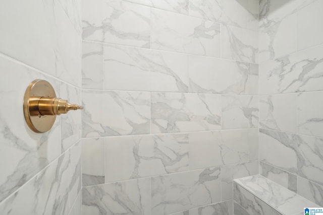 interior details featuring a tile shower