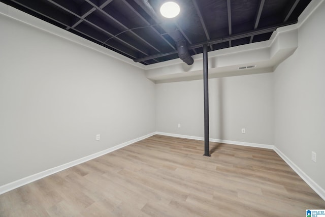 basement with light hardwood / wood-style flooring