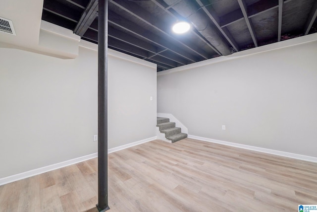 basement with hardwood / wood-style floors