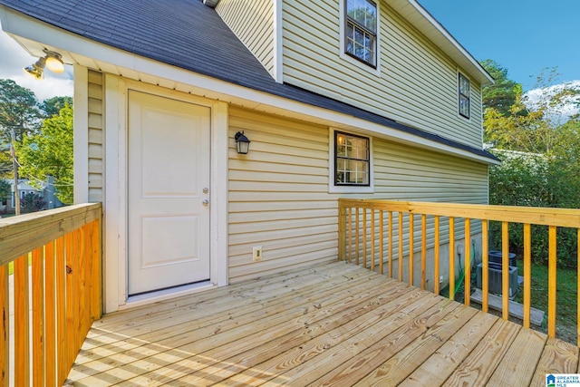 wooden terrace featuring cooling unit