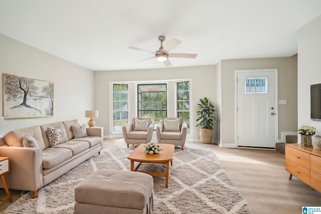 living room featuring ceiling fan and light wood-type flooring