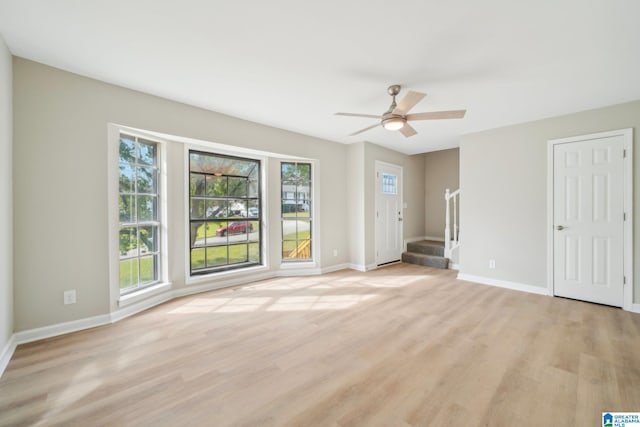 unfurnished living room featuring light wood-type flooring and ceiling fan