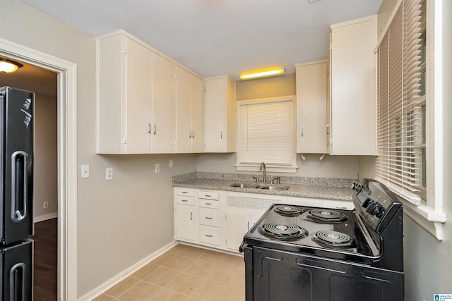 kitchen featuring black appliances, sink, and white cabinets