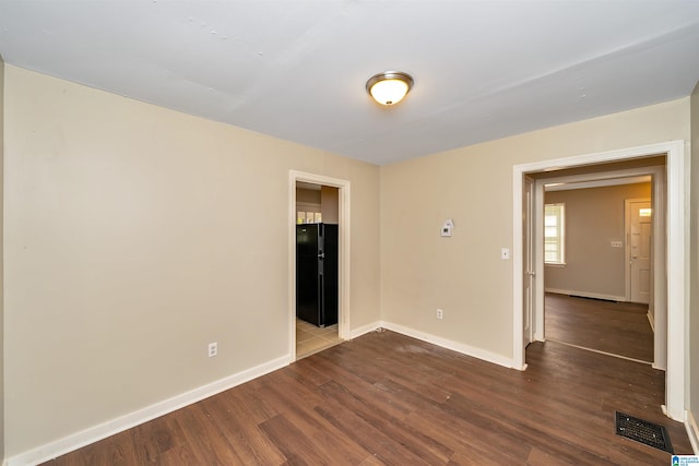 empty room with hardwood / wood-style floors