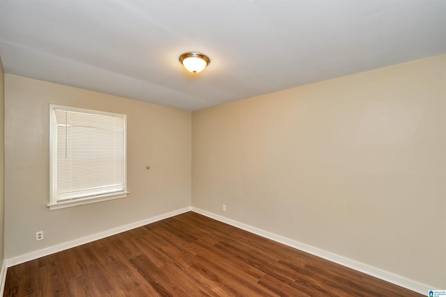 spare room featuring dark hardwood / wood-style flooring