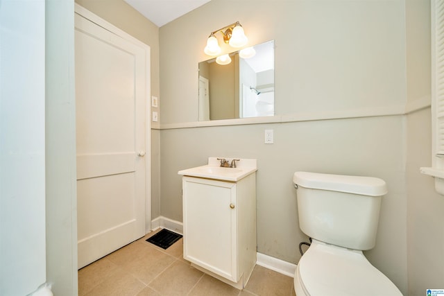 bathroom featuring vanity, tile patterned floors, and toilet