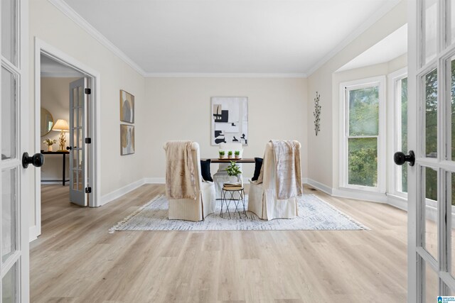 dining area featuring light wood-type flooring, french doors, and crown molding