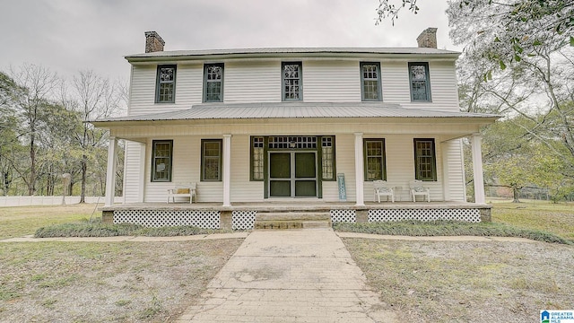 farmhouse inspired home featuring covered porch