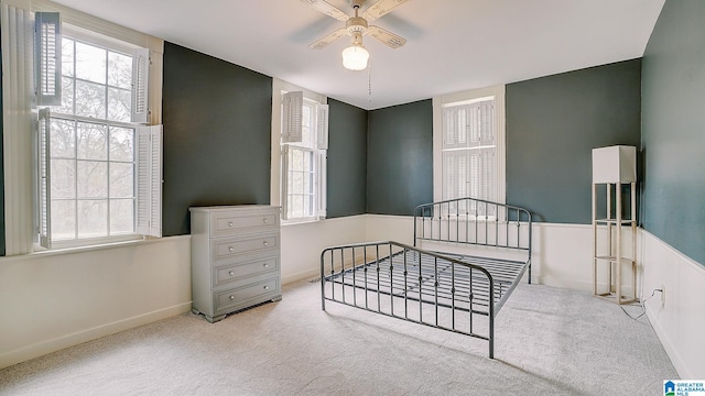 bedroom with ceiling fan and light colored carpet