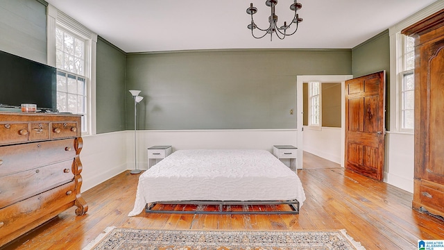 bedroom featuring light hardwood / wood-style flooring and a notable chandelier